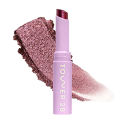 Eyeshadow with glittery texture and 'Tower 28' branding on a white background [Studio 28]